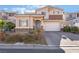 Charming two-story home with a two-car garage and landscaped front yard at 7321 Aspire Ct, Las Vegas, NV 89113