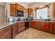 Well-equipped kitchen featuring wood cabinetry, granite countertops, and modern appliances at 7321 Aspire Ct, Las Vegas, NV 89113