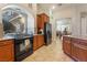 Bright kitchen featuring wooden cabinets, modern appliances, and a large arch window at 7321 Aspire Ct, Las Vegas, NV 89113