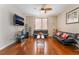 Stylish living room features modern sofas, hardwood floors, and natural light at 7321 Aspire Ct, Las Vegas, NV 89113