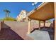 Gravel backyard with covered patio and view of house at 7337 Tealwood St, Las Vegas, NV 89131