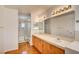 Double vanity bathroom with shower and wood-look floors at 7337 Tealwood St, Las Vegas, NV 89131