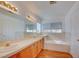 Bathroom boasts double sinks, a bathtub, and wood flooring at 7337 Tealwood St, Las Vegas, NV 89131