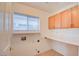 Laundry room with built-in cabinets and shelving at 7337 Tealwood St, Las Vegas, NV 89131