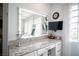 Vanity area with a large lighted mirror and granite countertop at 7435 Sun Summit Ct, Las Vegas, NV 89178