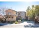 Two-story house with stone accents and a three-car garage at 7435 Sun Summit Ct, Las Vegas, NV 89178