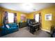 Bright home office with teal couch, desk, and large window at 7435 Sun Summit Ct, Las Vegas, NV 89178