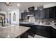 Spacious kitchen with granite countertops and dark cabinets at 7435 Sun Summit Ct, Las Vegas, NV 89178