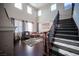 Two-story living room with hardwood floors and a grand staircase at 7435 Sun Summit Ct, Las Vegas, NV 89178