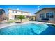 Relaxing pool area with a lush green backyard at 7435 Sun Summit Ct, Las Vegas, NV 89178