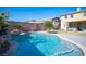 Freeform swimming pool with a waterfall feature and lush landscaping at 7435 Sun Summit Ct, Las Vegas, NV 89178