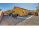 Home's backyard with gravel, walkway, and covered patio at 7666 Rainbow Cove Dr, Las Vegas, NV 89131