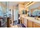 Elegant bathroom with double sinks, large mirror, and a walk-in shower at 7666 Rainbow Cove Dr, Las Vegas, NV 89131