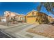 House exterior with a two-car garage and palm trees at 7666 Rainbow Cove Dr, Las Vegas, NV 89131