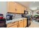 Kitchen features granite countertops, wood cabinets, and stainless steel appliances at 7666 Rainbow Cove Dr, Las Vegas, NV 89131