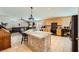 Island kitchen with granite countertops and light wood cabinets at 7666 Rainbow Cove Dr, Las Vegas, NV 89131