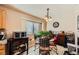 Cozy kitchen nook with a glass-top table and four chairs at 7666 Rainbow Cove Dr, Las Vegas, NV 89131