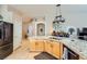 Kitchen with granite countertops, light wood cabinets, and a large island at 7666 Rainbow Cove Dr, Las Vegas, NV 89131