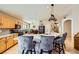 Kitchen features granite countertops, an island with seating, and wood cabinets at 7666 Rainbow Cove Dr, Las Vegas, NV 89131