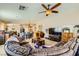 Spacious living room featuring a large sectional sofa and a view into the kitchen at 7666 Rainbow Cove Dr, Las Vegas, NV 89131