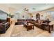 Living room with a large sectional sofa, coffee table, and wood flooring at 7666 Rainbow Cove Dr, Las Vegas, NV 89131