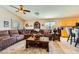 Bright living room with a sectional sofa and open view to the kitchen at 7666 Rainbow Cove Dr, Las Vegas, NV 89131