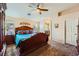 Large main bedroom with ceiling fan, wood furniture, and teal bedding at 7666 Rainbow Cove Dr, Las Vegas, NV 89131