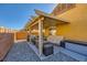 Covered patio with pergola, fire pit and ample seating at 7666 Rainbow Cove Dr, Las Vegas, NV 89131