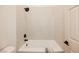 Bathtub with white tile surround and black fixtures at 7695 Silver Wells Rd, Las Vegas, NV 89149