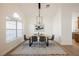 Bright dining room with modern furniture, a large window, and an elegant chandelier at 7695 Silver Wells Rd, Las Vegas, NV 89149