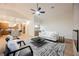 Open-concept living room featuring modern furnishings, a ceiling fan, and seamless access to the kitchen at 7695 Silver Wells Rd, Las Vegas, NV 89149