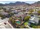 This is an aerial view of a home showcasing a refreshing pool, lush landscaping, and stunning mountain views at 790 Tossa De Mar Ave, Henderson, NV 89002