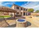 Large backyard featuring covered patio, outdoor kitchen, fire pit, and pool at 790 Tossa De Mar Ave, Henderson, NV 89002