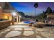 Backyard featuring a pool, waterslide, built-in outdoor kitchen and lounge area; perfect for entertaining at 790 Tossa De Mar Ave, Henderson, NV 89002