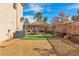 Backyard featuring artificial turf, desert landscaping, and a covered patio area at 790 Tossa De Mar Ave, Henderson, NV 89002