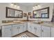 Bright bathroom featuring dual sinks, framed mirrors, and modern cabinetry at 790 Tossa De Mar Ave, Henderson, NV 89002