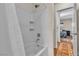 Bathroom featuring a white tiled shower and a door to the bedroom at 790 Tossa De Mar Ave, Henderson, NV 89002