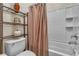 Clean bathroom with white tiled tub and shower, plus a sleek shelving unit at 790 Tossa De Mar Ave, Henderson, NV 89002