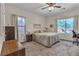 Comfortable bedroom with neutral carpet and a view of the backyard waterfall feature at 790 Tossa De Mar Ave, Henderson, NV 89002