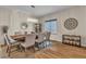 Dining room features a modern chandelier, wood table, and stylish decor at 790 Tossa De Mar Ave, Henderson, NV 89002