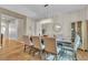 Dining room with seating for six, modern light fixture, and wood-look flooring at 790 Tossa De Mar Ave, Henderson, NV 89002