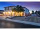 Inviting two-story home featuring a three-car garage, landscaped front yard, and beautiful evening sky at 790 Tossa De Mar Ave, Henderson, NV 89002