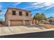 Inviting two-story home featuring a three-car garage and landscaped front yard under a blue sky at 790 Tossa De Mar Ave, Henderson, NV 89002