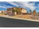 Inviting two-story home featuring a three-car garage and gravel front yard under a blue sky at 790 Tossa De Mar Ave, Henderson, NV 89002