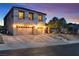 Inviting two-story home featuring a three-car garage and landscaped front yard under a colorful dusk sky at 790 Tossa De Mar Ave, Henderson, NV 89002