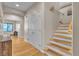 Hallway featuring wood floors, access to rooms, and a staircase to the upper level of the home at 790 Tossa De Mar Ave, Henderson, NV 89002