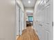 Hallway featuring wood-look floors and white doors, creating a clean, modern aesthetic at 790 Tossa De Mar Ave, Henderson, NV 89002