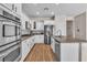 Spacious kitchen with white cabinets, granite countertops, and stainless steel appliances at 790 Tossa De Mar Ave, Henderson, NV 89002