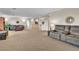 Large, open living room featuring a staircase and neutral carpet at 790 Tossa De Mar Ave, Henderson, NV 89002