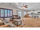 Inviting living space featuring wood floors, comfortable sofas, and access to a dining area and outdoor space at 790 Tossa De Mar Ave, Henderson, NV 89002